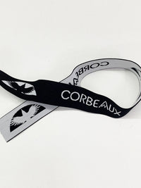 1 1/4" Black/Bright Silver Branded Text Medallion Jacquard Elastic - Corbeaux Clothing - BY THE 5 YARD PIECE