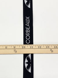 1 1/4" Black/Bright Silver Branded Text Medallion Jacquard Elastic - Corbeaux Clothing - BY THE 5 YARD PIECE